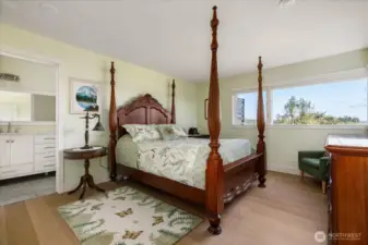 Main residence primary bedroom suite showing entrance to the bath at left. Walk-in closet is at left out of view.