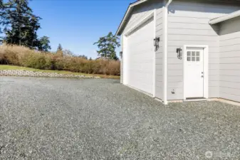 16x40 heated RV garage/shop adjoining the Guest Cottage has 16'x32' RV space with 12'x12' garage door plus 16'x8' storage space with 7'x7' door, EV charging outlet. There is a 50-amp RV outlet and dump port, too.