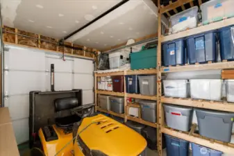Storage area at the rear of the RV garage/shop has its own 7'x7' door and is a great area to stash a riding mower or other toys.