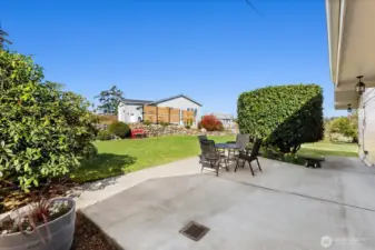 Primary Residence Patio with lovely terraced and landscaped yard. Guest cottage is seen in the background.