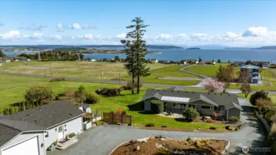 View of the Guest Cottage at left, circular driveway and the Primary Residence straight ahead.