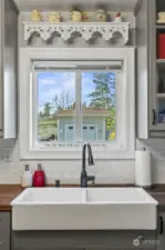 Farm house sink in kitchen facing the side of the property.