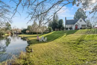 Front landscape of home pictured, along with fire pit and seating along creek.