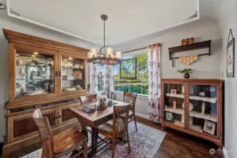 Dinning space along with a rustic chandiler to radiate the detailed trim and ceiling stencil.