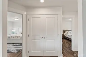 Laundry closet in  hallway between bedrooms