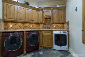 2 large washers and 1 dryer with counter space