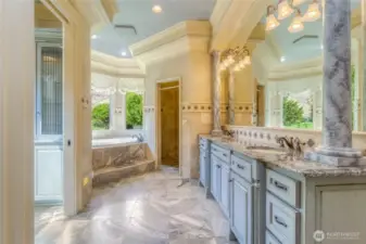 Primary suite bathroom with tile heated floors and double vanity