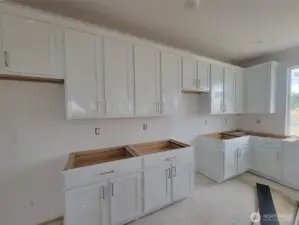 White cabinets being installed