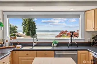 Imagine doing dishes with this incredible view—keep an eye out for whales!