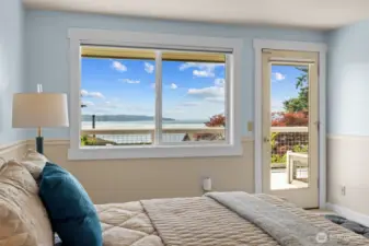 Primary suite retreat with panoramic views and direct access to the deck—ideal for soaking in the scenery or a quiet moment outdoors.