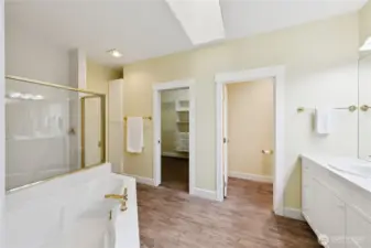 The spa-inspired primary bath includes a soaking tub, oversized shower, double sinks, and a private water closet designed for comfort and privacy.