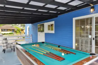 Covered outdoor deck with TV space and pool table (stays with house)