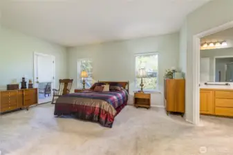 Expansive primary suite has direct access to the back deck