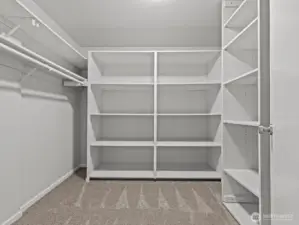 The highly functional walk-in closet has more than enough space for the most extensive wardrobe.