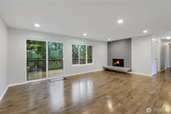 Large Living Room with fireplace and slider out to Upper Deck.