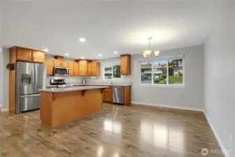 Dining Room and eat at island in the Kitchen with stainless steal appliances.