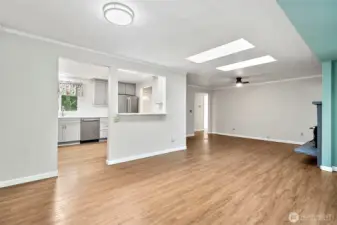 Looking towards the kitchen and living room from the dining room.  Lots of light streaming in from the skylights.