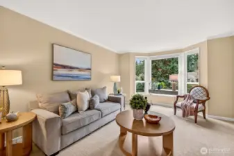 The bay window brings in soft light and a peaceful outlook to evergreens and the neighborhood beyond. It is an ideal spot for a reading corner, conversation area, or simply enjoying the treed setting that defines English Hill.
