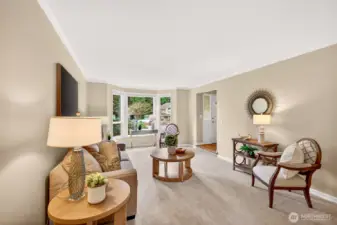 A wide view of the living room highlights the home’s comfortable proportions and the easy connection back to the entry and main level flow. This is the kind of space that adapts well, whether you prefer a formal sitting area or a relaxed everyday lounge.
