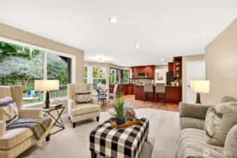 Great room feel with the kitchen, dining nook, and living area all connected, enhanced by abundant natural light and direct access to the deck and fenced yard.