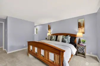 Another view of the primary bedroom shows the generous scale and clean lines, with calming tones and plush new carpet underfoot. The room feels airy and comfortable, a true retreat at the end of the day.
