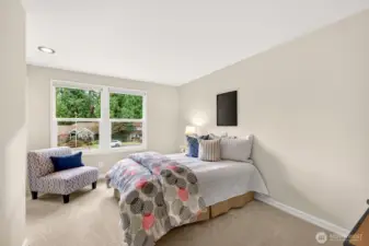 Another bedroom with a wide window wall and a simple, flexible layout that makes it easy to set up sleeping space plus a desk, or a reading corner.