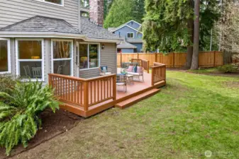 A ground level view of the deck shows easy access and a strong connection to the home’s interior spaces. The outdoor layout feels intentional, with defined zones and comfortable circulation