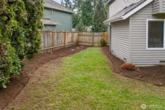 The side yard provides additional outdoor utility, offering extra space that is often missing in similar homes. It is ideal for a garden zone, storage needs, or a contained run for pets.