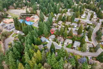 This neighborhood aerial highlights the surrounding tree canopy and the home’s placement within a quiet residential setting. The labeled reference points make it easy to visualize proximity to nearby amenities, including Sunrise Elementary.