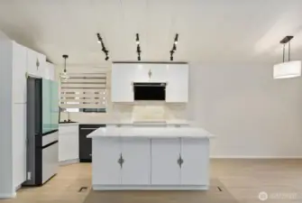 fully renovated, high-end kitchen is the heart of the home, featuring stylish cabinetry, sleek countertops, and a spacious island with seating