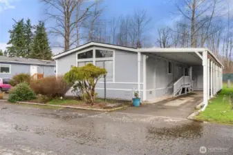 oversized tandem carport for two vehicles, and a rear storage shed