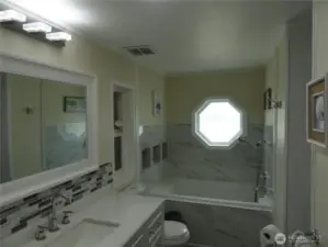 Large bathroom off of the primary bedroom.  Includes new counter top, back splash and Jetted bathtub with new tile work. As you see, natural lighting as well!