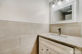 ADU bathroom with tile and granite countertops