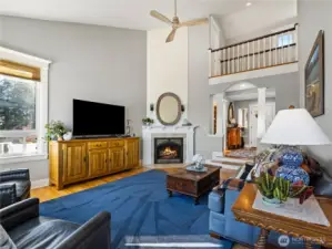The gas fireplace is dressed up with white shiplap. From the second floor you have a view of the living room from the cat walk.