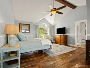 The primary bedroom has scraped wood flooring.
