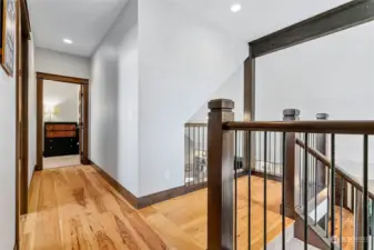 Upstairs landing, beautiful hickory hdwd flooring carried throughout home. Large linen closet behind photo also has a laundry shoot to utility room below!