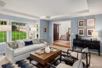 Living room features inset ceiling with crown molding.