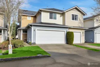 House front with two car garage.