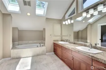 Primary ensuite bath view 1, love the soaking tub, skylights, quality flooring and giant double vanity with windows above! Amazing.