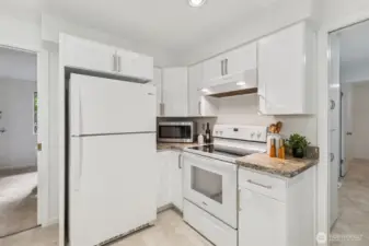 The modern range and sleek hood complement the clean design. It’s a kitchen you’ll love to use and be proud to show off. New, vinyl flooring for a fresh, cohesive look.