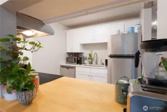 Updated kitchen with modern, Shaker cabinetry and smart, stylish design. This pass through offers convenience for serving from the kitchen to the dining room.