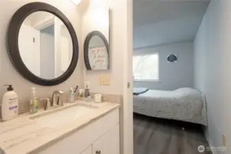 Updated primary bathroom featuring NEW tile flooring, cabinetry and tub/shower.