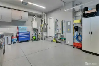 Incredible garage with epoxy flooring, EV charger, and extra strorage.