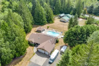 Large Rambler on approximately 5 acres with a shop, in-ground pool, pool house and more!