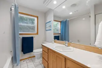 Main bathroom in hallway has a jetted tub.