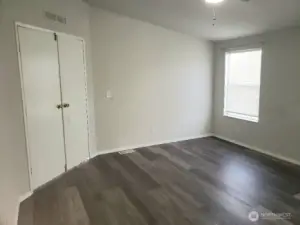 Another View of the Picture Huge Primary Master Bedroom with Double Entry Doors Newer Trim, and Vinyl Plank Flooring.