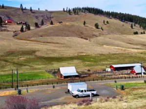 Looking from the home down to the RV parking/barn/garage building pad and across the valley to the hills of Swauk Valley
