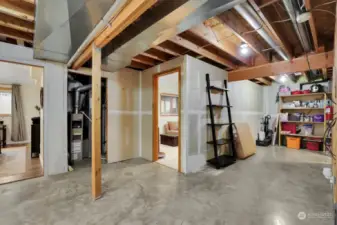 Unfinished basement area, looking towards two finished rooms