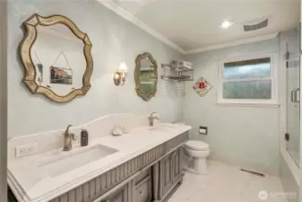 tTe Common Main Floor Bathroom features Custom Vanity, Heated Tile Floors, Insulated Walls, Frameless Glass Doors and Custom Lighting