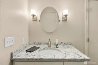 Well-lit vanity and undermount sink in lower-level bathroom
